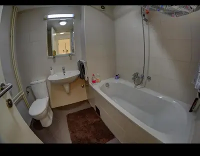 a bathroom with a tub and a toilet and a sink at Belvile one bedroom apartment in Belgrade