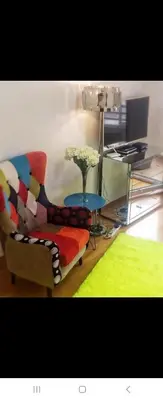 a living room with a couch and a table with a vase of flowers at Belvile one bedroom apartment in Belgrade