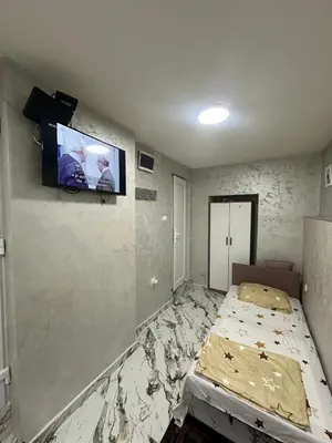 a bedroom with a bed and a tv on the wall at Dream 10 in Belgrade