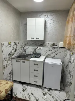 a kitchen with white appliances and marble walls at Dream 10 in Belgrade