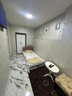 a room with two beds and a table in it at Dream 10 in Belgrade