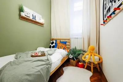 a small bedroom with a bed and a window at Fireplace Retreat 115m2 with Balcony Old Town in Belgrade
