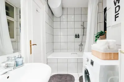 a white bathroom with a sink and a shower at Fireplace Retreat 115m2 with Balcony Old Town in Belgrade