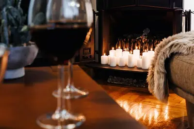 two glasses of wine and candles on a table at Fireplace Retreat 115m2 with Balcony Old Town in Belgrade