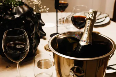 a bottle of wine in a bucket next to two glasses at Fireplace Retreat 115m2 with Balcony Old Town in Belgrade