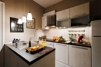 a kitchen with a sink and a counter with a bowl of oranges at Fireplace Retreat 115m2 with Balcony Old Town in Belgrade