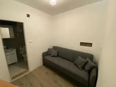 a living room with a couch and a mirror at Apartman Vera