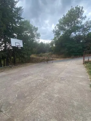 an empty parking lot with a basketball hoop at Apartman Vera