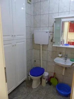 a bathroom with a blue toilet and a sink at Tackica 13 Apartment in Belgrade