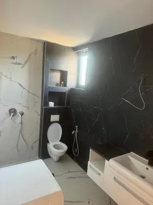 a black and white bathroom with a toilet and a sink at Infinity Lux Residence in Novi Banovci