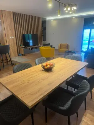 a wooden table with a bowl of fruit on it at Infinity Lux Residence in Novi Banovci