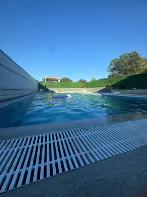 a swimming pool with blue water at Infinity Lux Residence in Novi Banovci