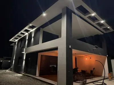 a building with a lit up facade at night at Infinity Lux Residence in Novi Banovci
