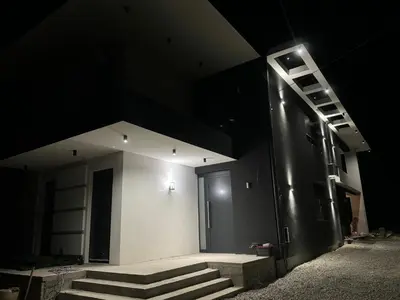 a building with stairs and a door at night at Infinity Lux Residence in Novi Banovci