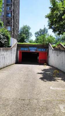 a tunnel in a parking lot with a red door at 14th Heaven Apartment in Belgrade