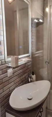 a bathroom with a white sink and a shower at 14th Heaven Apartment in Belgrade