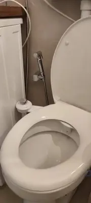 a bathroom with a white toilet with the lid up at 14th Heaven Apartment in Belgrade