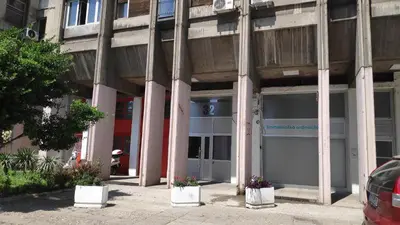 a building with two garage doors in front of it at 14th Heaven Apartment in Belgrade