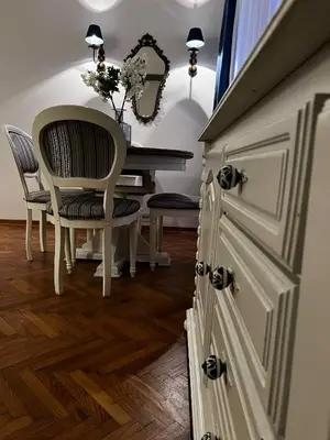 a dining room with a table and a chair at Atelier Museum in Belgrade