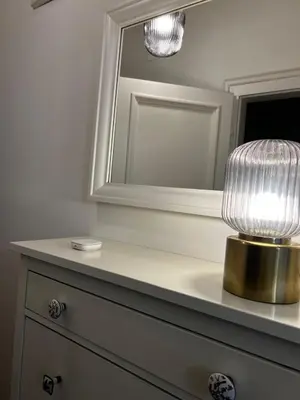 a bathroom with a mirror and a lamp on a dresser at Atelier Museum in Belgrade