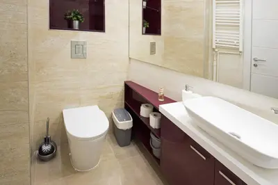 a bathroom with a toilet and a sink and a mirror at The Boutique Apartment in Belgrade