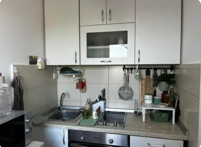 a kitchen with white cabinets and a sink at Mileshevska Studio in Belgrade