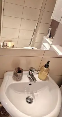 a bathroom sink with a soap dispenser on it at Mileshevska Studio in Belgrade