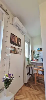 a room with a white wall with flowers on it at Mileshevska Studio in Belgrade