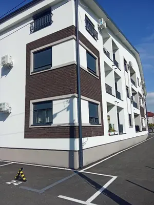 a building with a brick in a parking lot at Vido in Belgrade