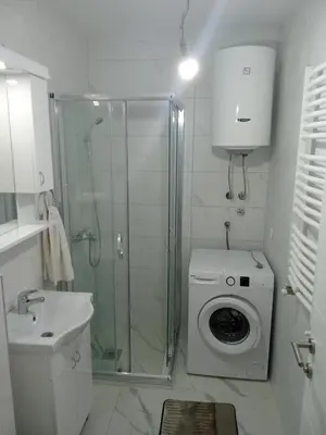 a bathroom with a shower and a washing machine at Vido in Belgrade
