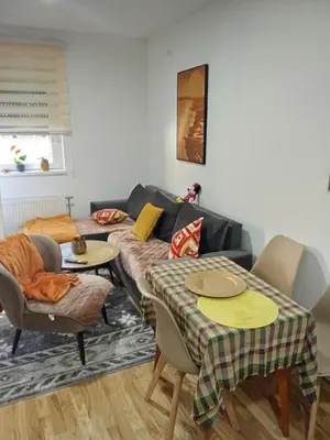 a living room with a couch and a table and chairs at Vido in Belgrade