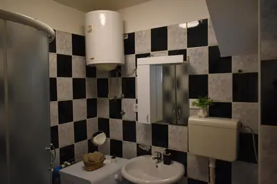 a bathroom with a sink and a toilet at Apartman Play in Belgrade