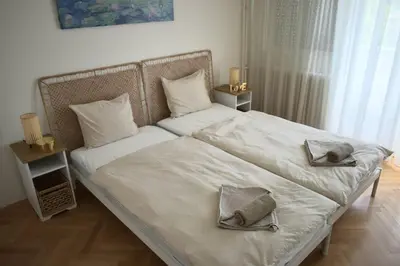a bed with two hats and pillows on it at Apartman Play in Belgrade