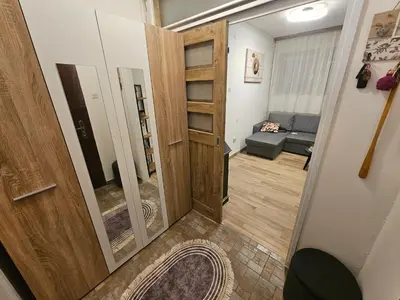 a hallway with a door and a living room at Apartman Sandra in Belgrade
