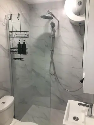 a bathroom with a shower and a toilet and a sink at Beograd stan na dan in Novi Beograd