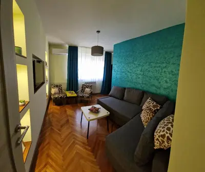 a living room with a couch and a table at Apartman Pegaz in Lazarevac