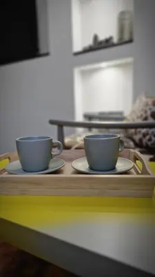 two coffee cups sitting on a wooden tray at Apartman Pegaz in Lazarevac