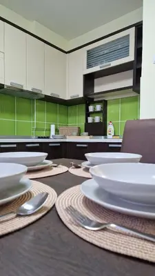 a kitchen with a table with white dishes on it at Apartman Pegaz in Lazarevac