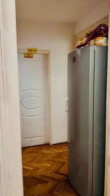 a refrigerator in a room with a door at BW Hostel in Belgrade