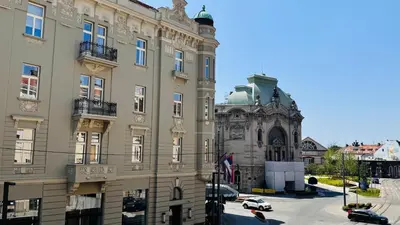 a building with a car parked in front of it at BW Hostel in Belgrade