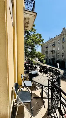 a balcony with a table and chairs on a building at BW Hostel in Belgrade