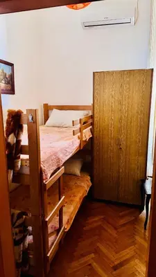 a room with a bunk bed and a wooden cabinet at BW Hostel in Belgrade