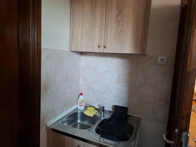 a kitchen sink with a bottle of soap and a keyboard at Apartmani Kula - Lux Apartman in Novi Banovci