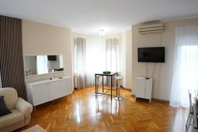 a living room with a couch and a television at Apartmani Kula - Lux Apartman in Novi Banovci