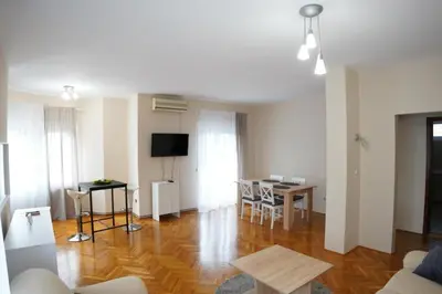 a living room with a couch and a table at Apartmani Kula - Lux Apartman in Novi Banovci