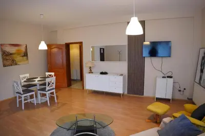 a living room with a table and a dining room at Apartmani Kula - Apartman 2 in Novi Banovci