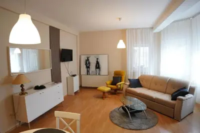 a living room with a couch and a table at Apartmani Kula - Apartman 2 in Novi Banovci