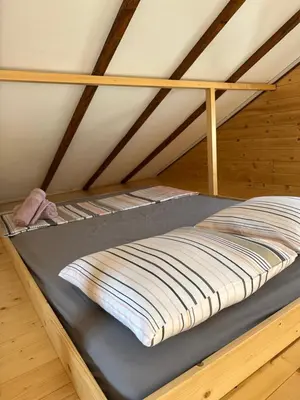 a bunk bed in a room with a roof at Splav na Savi in Ostružnica