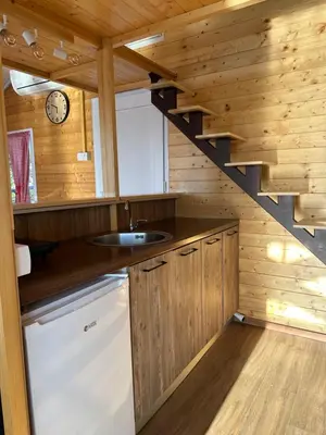 a kitchen with a sink and a staircase in a cabin at Splav na Savi in Ostružnica