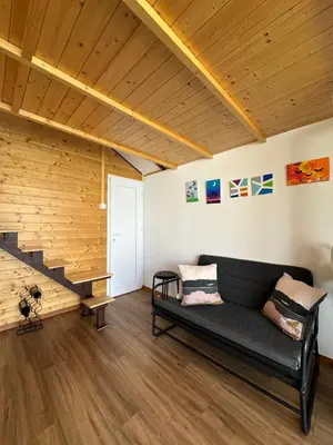 a living room with a couch and a staircase at Splav na Savi in Ostružnica